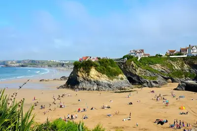 a group of people on a beach near the ocean at Newquay Sunset & Sea View Apartment in Town Centre in Newquay