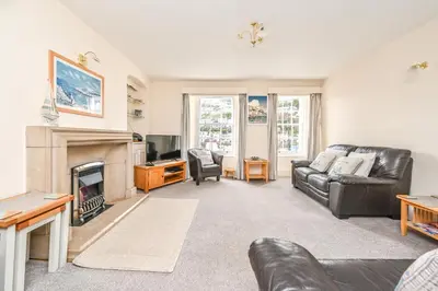 a living room with a couch and a fireplace at 3Bed Apartment Sleeps 5- Parking Wifi Near Beach in Looe