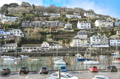 a harbor with boats in the water and houses at 3Bed Apartment Sleeps 5- Parking Wifi Near Beach in Looe
