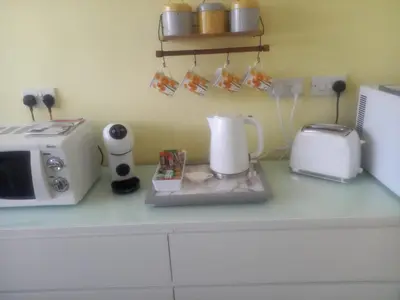 a kitchen counter with a coffee maker and a microwave at Self Contained Garden Annexe in Bodmin in Bodmin