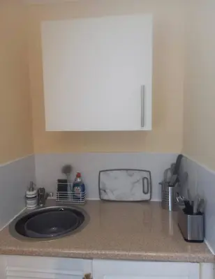 a kitchen counter with a sink and a white cabinet at Self Contained Garden Annexe in Bodmin in Bodmin