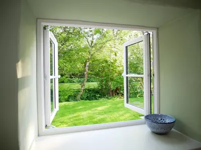 an open window with a bowl on a window sill at The Pigsty & Spa Garden at Tregoose Old Mill in Newquay