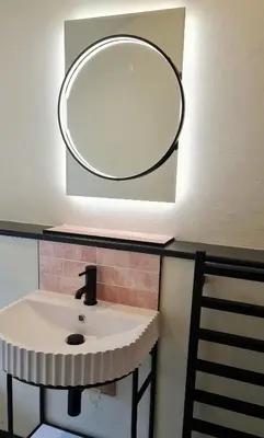 a bathroom with a sink with a mirror on the wall at The Pigsty & Spa Garden at Tregoose Old Mill in Newquay