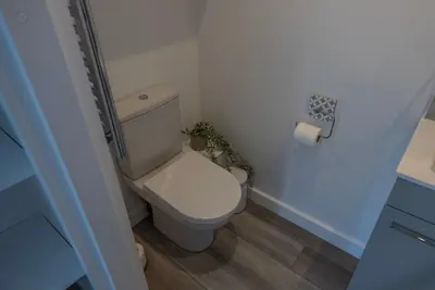 a small bathroom with a toilet and a roll of toilet paper at Olverstone Lodge, a beautiful Cornish lodge with wood burner & garden in St Austell