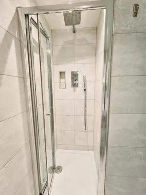 a shower with a glass door in a bathroom at 