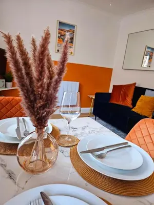 a dining room table with white plates and wine glasses at 
