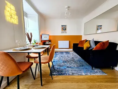 a living room with a black couch and a table at 