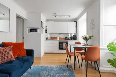 a living room with a blue couch and a table at 