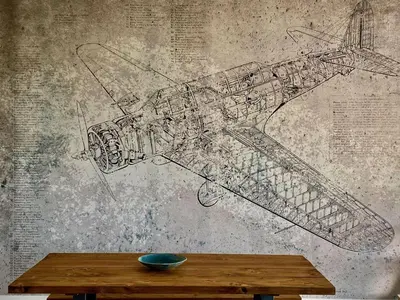 a drawing of a plane on a wall next to a table at Penthouse 53 Zinc - Sleeps 8 in Newquay