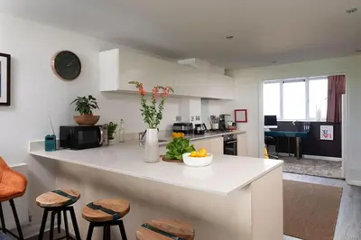 a kitchen with a counter with a bowl of fruit on it at Penthouse 53 Zinc - Sleeps 8 in Newquay