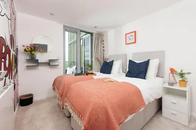 a bedroom with two beds and a window at Penthouse 53 Zinc - Sleeps 8 in Newquay