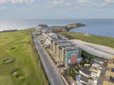 an aerial view of a building next to the ocean at Penthouse 53 Zinc - Sleeps 8 in Newquay