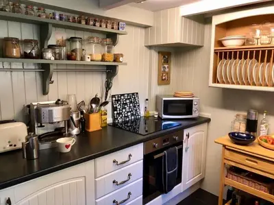 a kitchen with a counter top with a microwave at Coombe Cottage in St. Agnes