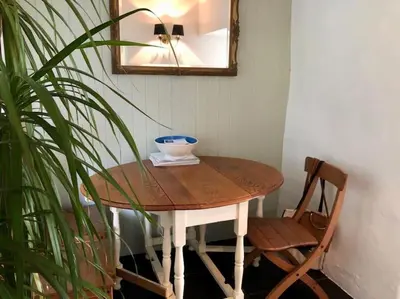 a table with a bowl on it next to a plant at Coombe Cottage in St. Agnes
