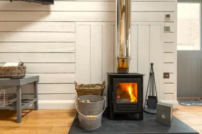 a fireplace in a room with a wall with at Gilliflower 1 bedroom cottage at Trethwale Barns Holiday Home in Saint Keyne