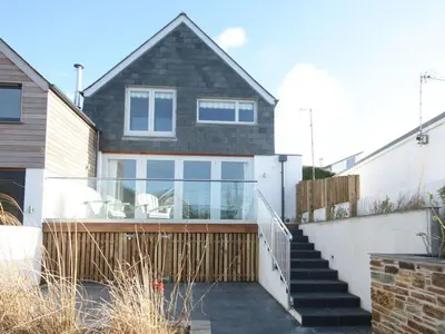 a house with a glass staircase in front of it at The Beach House in Wadebridge
