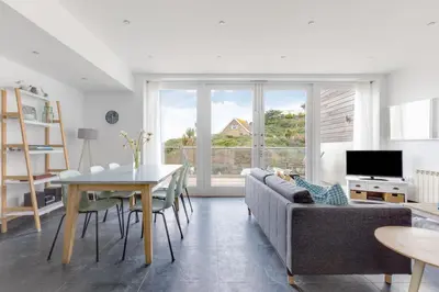 a living room with a couch and a table at The Beach House in Wadebridge