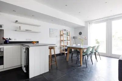 a kitchen and dining room with a table and chairs at The Beach House in Wadebridge