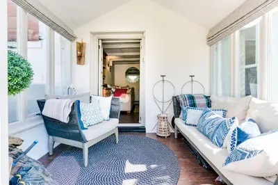 a living room with blue and white pillows at Luxury Fisherman’s Cottage Historic Port Isaac in Port Isaac