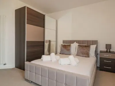a bedroom with a large bed with white pillows at 10 Quay Court in Newquay