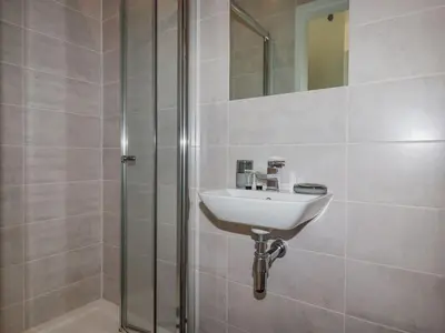 a bathroom with a sink and a shower at 10 Quay Court in Newquay