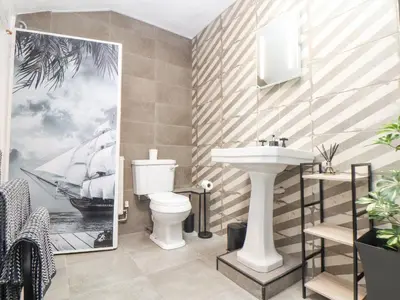 a bathroom with a sink and a toilet at Little Polgray in St Austell