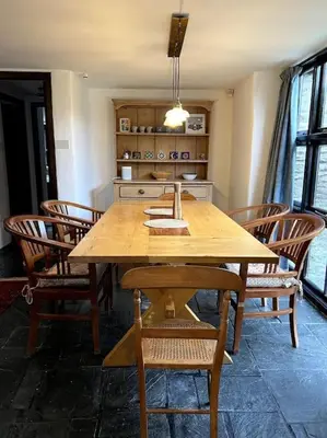 a wooden table and chairs in a room at Bay Tree Barn in Truro