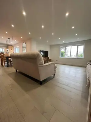 a large living room with a couch and a table at Amazing house sleeps 13 in Newlyn East