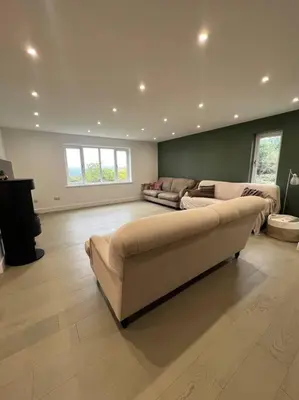 a large living room with a couch and a table at Amazing house sleeps 13 in Newlyn East