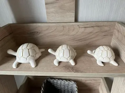 two stuffed turtles sitting on a wooden shelf at Modern Lodge with Amazing Views in Newquay