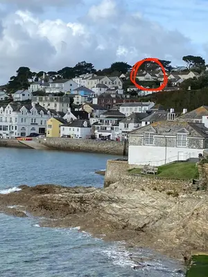 a red circle is sitting on top of a city at 5 SEAVIEW private parking w EV in Saint Mawes
