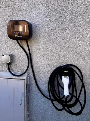 a cord plugged into a outlet on a wall at 5 SEAVIEW private parking w EV in Saint Mawes