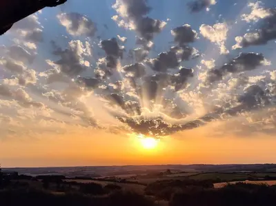 a sunset with a heart shaped cloud in the sky at Little Swelle Cabin with awesome Sea views in Poundstock
