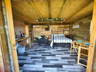 a room with a bed and a table at Little Swelle Cabin with awesome Sea views in Poundstock