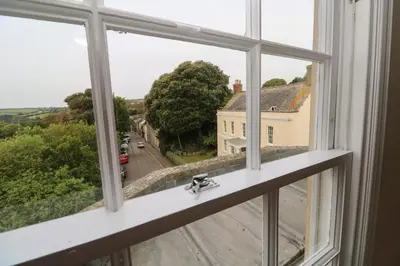 a window with a view of a street at The Penthouse in Helston