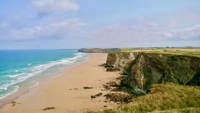 a view of a beach next to the ocean at Nook Cottage Seaside Charm & Countryside Calm in Newquay