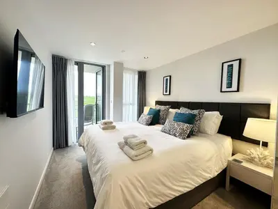 a bedroom with a large bed with towels on it at 24 Zinc in Newquay