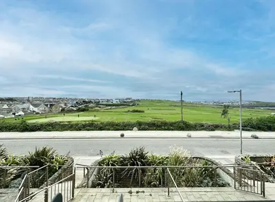 an empty road with a golf course in the background at 24 Zinc in Newquay