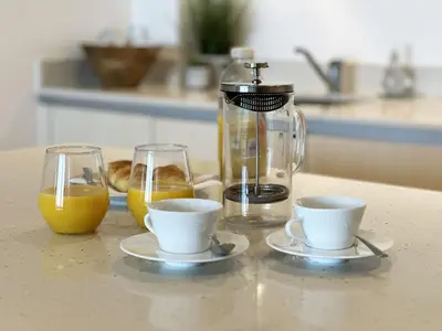 a kitchen counter with two cups and a coffee maker at 24 Zinc in Newquay
