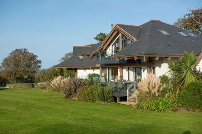 a house with a green lawn in front of it at St Ia, Castle Approach, Tregenna Castle in St Ives