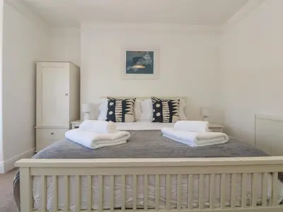 a bed with two white towels on top of it at 21 Passage Street formerly Panacea in Fowey