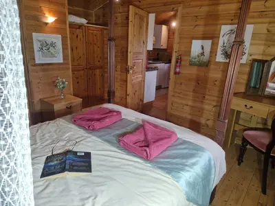 a bedroom with a bed with pink towels on it at Polgwedhen Lodge in Truro