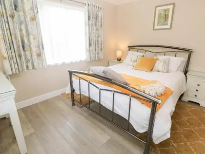 a bedroom with a bed and a window at Little Roskrow in Penryn