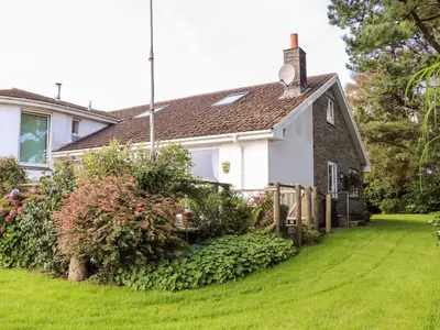 a white house with a green yard at Little Roskrow in Penryn