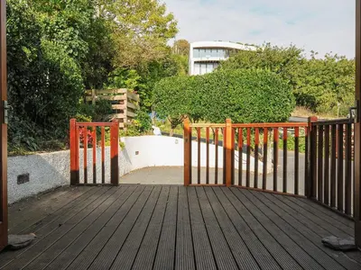 a wooden gate on a wooden deck at Little Trevallan in Looe