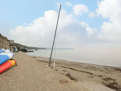 a pole on the beach with a boat on it at Little Trevallan in Looe