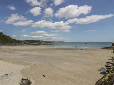 a view of a beach with people in the water at Little Trevallan in Looe