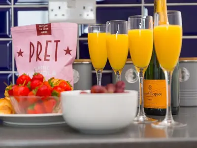 a group of glasses of orange juice and a bowl of fruit at 5 St Brigids in St Ives