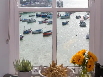 a window view of a harbor with boats in the water at 5 St Brigids in St Ives