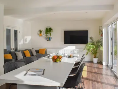 a living room with a white table and a couch at Eighty Two in Newquay